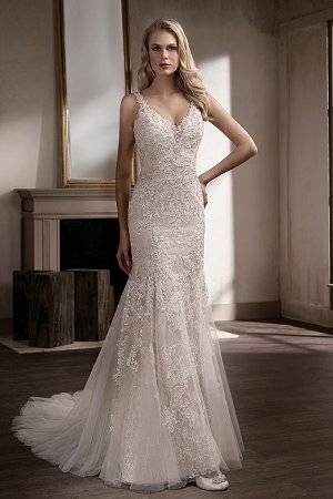Beautifully embellished lace adorns this dramatic fit and flare wedding gown,  with a sweetheart neckline and subtle sparkle