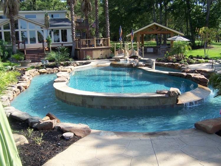 Frameless glass walls and simple contemporary pool and landscaping