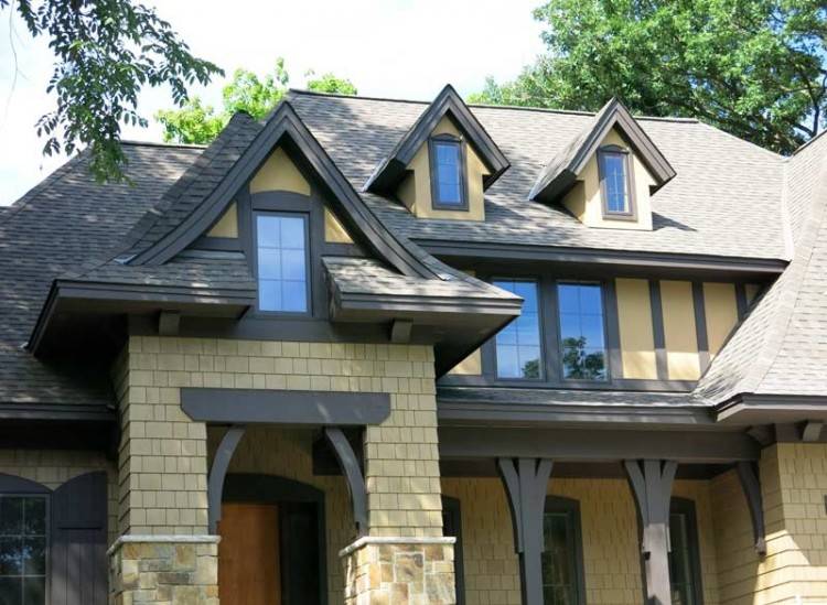 Tudor style home remodel with wood brackets, rain chain and muted exterior  trim details