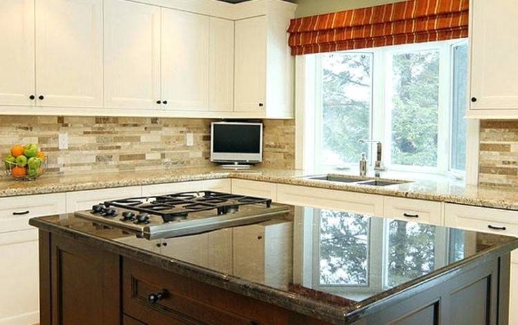 White kitchen cabinets, black countertops and white subway tile with white  grout