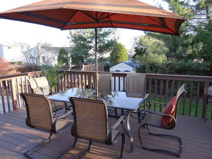 Man and woman sitting in Jacuzzi on deck; Outdoor kitchen and patio  living space