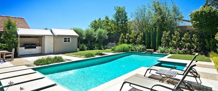 The steep level change between the main garden and pool area provided scope  for raised planters, planted with Orange trees and Rosemarinus prostratus