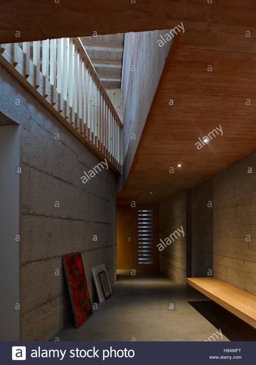 View of dining area with wooden table  set and red wall hallway