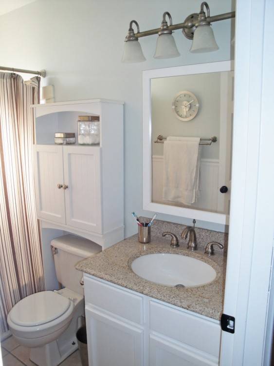 Fabulous bathroom with light gray paint on top half of walls and white  beadboard on bottom half of walls framing window in lieu of mirror with  gray cornice