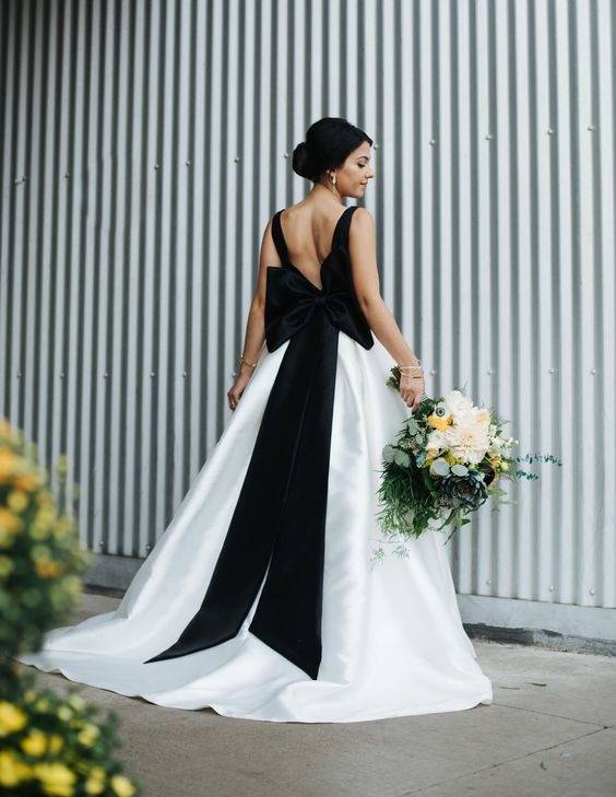 Consider adding some black elements to your white wedding gown without  going all black and shocking your elders