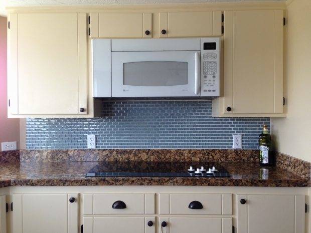 The diagonal planking of this wood floor accents the angled countertops of  this kitchen