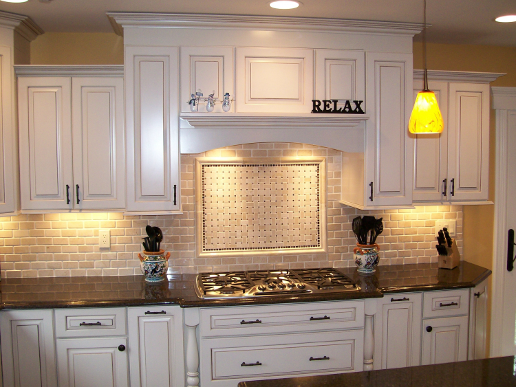 Off white with clipped corners on the bump out sink, granite  countertop, arched valance