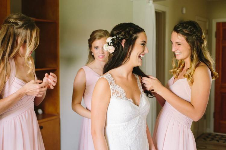 Lace wedding dress hanging from a rustic barn