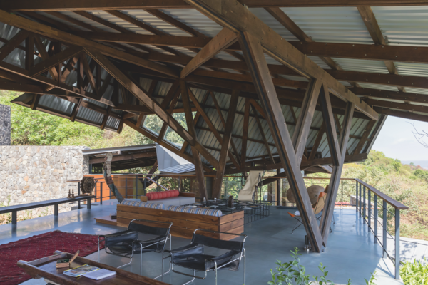 A complex, angled structure shades and protects the main outdoor living  space