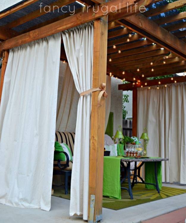 Use shower curtains outdoors to create curtains on porch