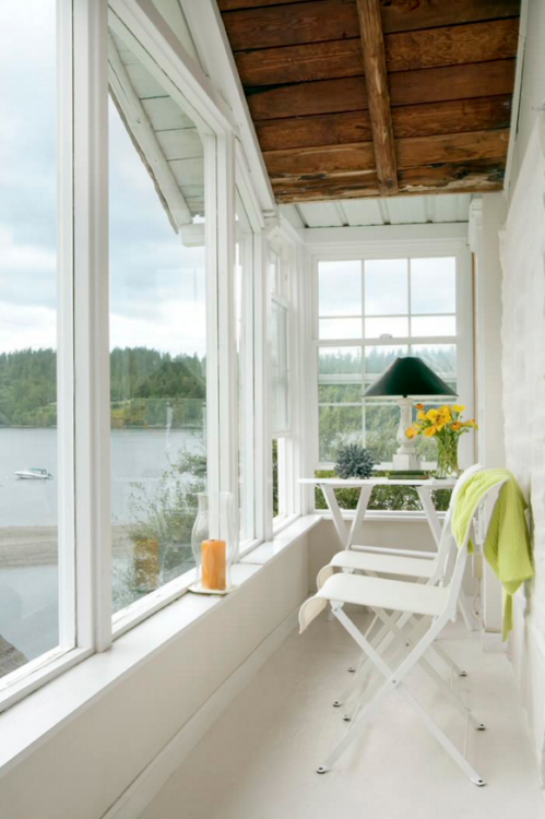 Reclaimed wood adorns the walls of this creative, rustic sunroom [Design:  Appalachian Antique